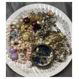 Plate of costume jewelry lots of ear bobs