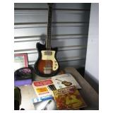 Bass guitar with music books