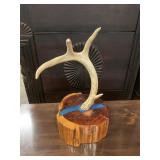 Handcrafted deer antler on wood stump