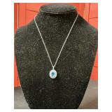 Sterling silver blue topaz double halo pendant