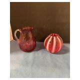 Cranberry glass pitcher and unmarked Fenton deco