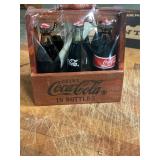 Miniature Coca-Cola glass bottles in crate
