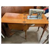 White Sewing Machine in wood cabinet