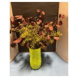Green face with artificial flowers