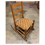 Ladder back rocking chair with woven seat