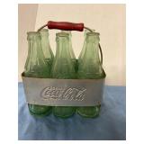 Vintage Coca-Cola bottles in metal rack