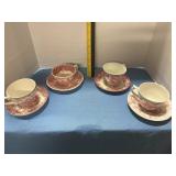 Assorted cups with saucers