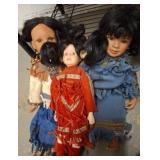 Trio of Porcelain Dolls in Traditional Attire