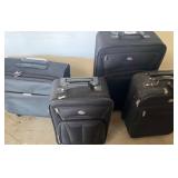 Four Black Rolling Suitcases