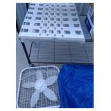 Metal Shelving Unit, Box Fan, and Blue Tarp