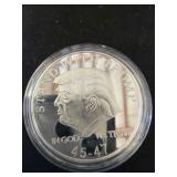 Silver-Toned Coin with Trump Motif