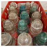 Glass Insulators in Red Plastic Crate