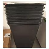 Stack of Black Plastic Trash Bins