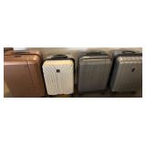 Four Hard-Shell Rolling Suitcases