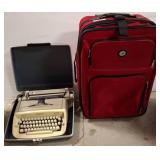 Vintage Typewriter and Red Rolling Luggage