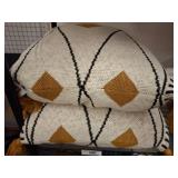 Two Geometric Throw Pillows With Tassels