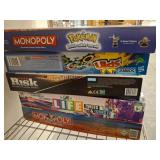 Stack of Board Games Including Monopoly and Risk