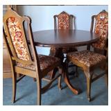 Round Wood Dining Table with Four Upholstered Chai
