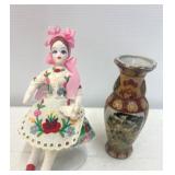Cloth Doll with Floral Dress and Decorative Vase