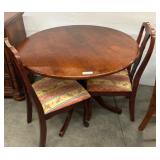 Round Wooden Table with Two Upholstered Chairs