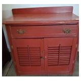Red Wooden Cabinet With Louvered Doors