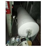 LARGE ROLL OF FOAM MATERIAL ON WHEELS