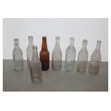 8 GLASS ADVERTISING BOTTLES