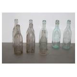 7 GLASS ADVERTISING BOTTLES