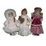 Trio of Porcelain Dolls with Detailed Attire