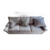 Three Cushion White Upholstered Sofa With Pillows