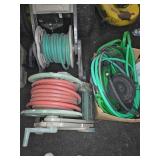 Two Hose Reels with Hoses and Box of Garden Hoses