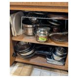 CABINET OF STAINLESS POTS AND MORE