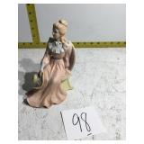 Woman figurine sitting in the chair