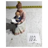 Woman figurine sitting with a boy on lap