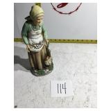 A woman gathering eggs figurine