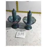 Two carnival glass candleholders with candles