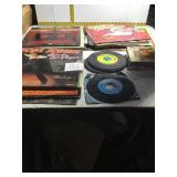 Stack of miscellaneous record albums and 45