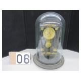 Four column mantel clock under glass dome