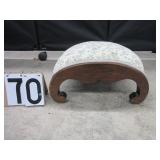 Arched upholstered foot stool