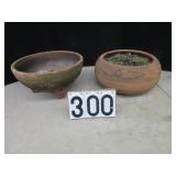 2 mismatched clay planters