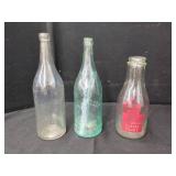 THREE ASSORTED ADVERTISING GLASS BOTTLES