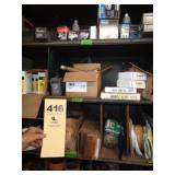 Three shelves: shower heads, oil filters,
