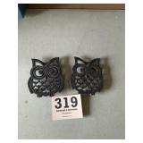 Two cast owl trivets
