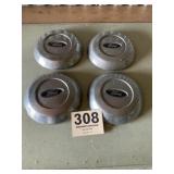 Four Ford hubcaps