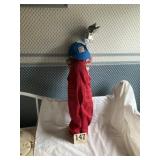 Large doll standing in corner