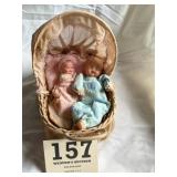 Two dolls in cradle