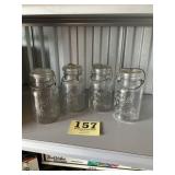 Four glass top wire bail canning jars