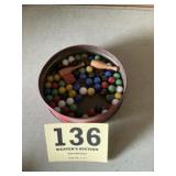 Tin of marbles