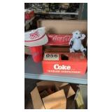 Coca Cola bench, bear, cup, hat and a box