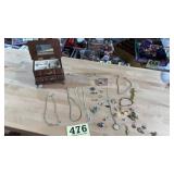 Small wooden jewelry box with some rings in it